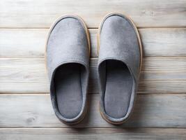 Gray Wool Slippers on Light Wooden Background photo