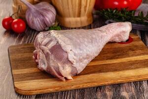 A raw chicken on a cutting board with vegetables and other ingredients photo