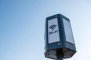 Public Wi-Fi Hotspot Installed on a Metal Pole Against a Clear Sky in an Urban Area Providing Internet Access for Nearby Users photo