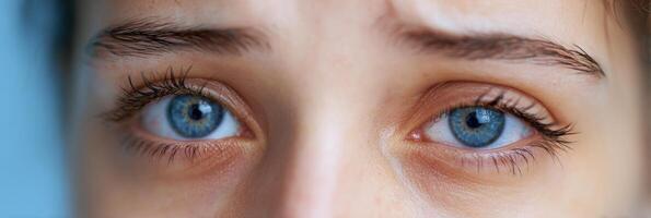 Eyes Exhibiting Twitching From Insomnia Against a Soft Blue Background During Late Night Hours photo