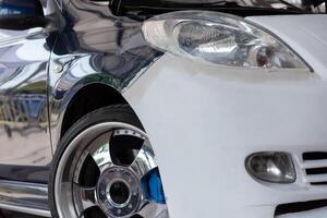 A close up of a white car with blue rims photo
