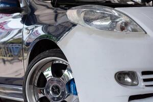 A white car with a blue stripe on the front photo