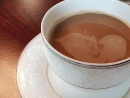 A cup of coffee with a heart shape in it photo