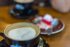 A cup of coffee sitting on a table photo