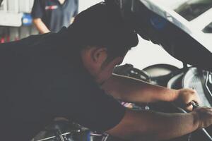 A man working on a car in a garage photo