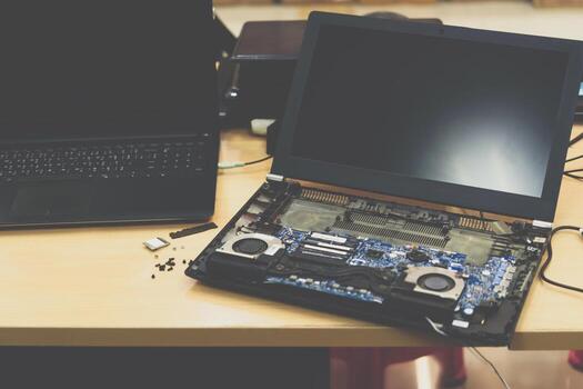 A laptop computer sitting on a table with a keyboard and mouse photo