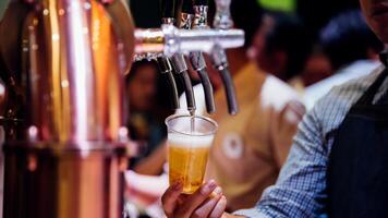 A man is pouring beer into a glass photo