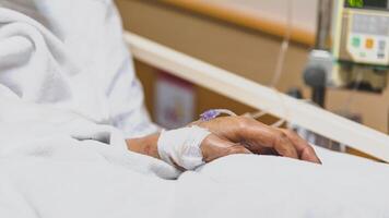 A person in a hospital bed with a drip photo