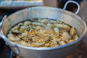 Fried a food by deep fry with boiling oil in pot photo