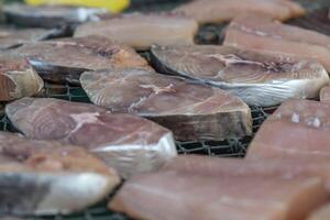 A bunch of fish on a wire rack photo