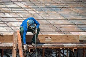 A man working on a roof with a hammer photo