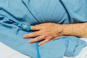 A person laying in bed with a blue blanket photo