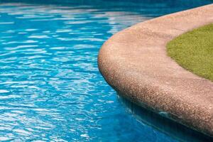 Swimming pool with sandstone and grass floor photo