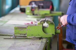 Working hands at the vise. Working locksmith photo