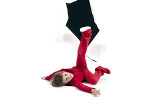 A child from a hole in paper. Boy shows cardboard. Fall out of the billboard. photo