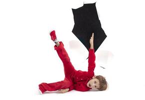 A child from a hole in paper. Boy shows cardboard. Fall out of the billboard photo
