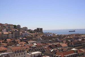 The view of the city from view point. The roofs of the houses and the river. Lisbon, Portugal. photo