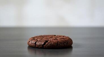 A chocolate cookie sitting on a table photo