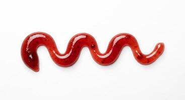 A red liquid is being poured into a wavy shape photo