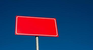 A red sign on a pole photo