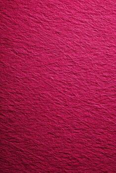 Vibrant crimson textured paper with subtle folds, creating a rich and dynamic background surface photo