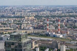 View of the Sprawling Urban Landscape of Moscow Featuring Industrial Structures and Modern Architecture on a Clear Day photo