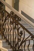 Wrought Iron Railing Design Embellishes Architectural Stairway in Elegant Building Interior photo