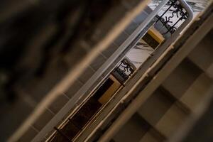 Staircase Interior View With Railings in a Retro Building Showcasing Geometric Lines and Shadows During Daytime photo