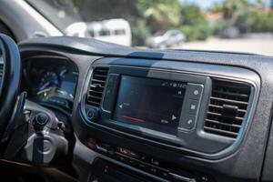 Modern Car Interior With Touchscreen Display Showcasing Audio Controls and Dashboard Features in a Sunny Outdoor Setting photo