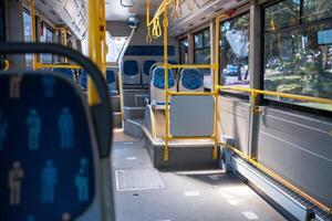 Interior of a Public Bus Showing Seating Arrangements and Accessibility Features During Daytime photo