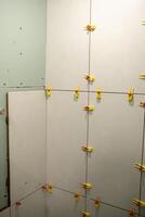 Wall Installation Process With Clips Used to Secure Panels in a Corner During a Renovation Project photo