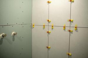 Drywall Installation in Progress With Clamps Securing Panels in a Construction Project photo