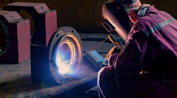 Welding steel structures and bright sparks in construction indust photo