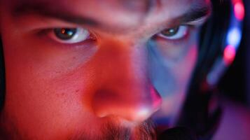 Intense Gamer Concentrates on Screen With Focused Gaze Illuminated by Bright Light and Neon Shadows in a Dark Gaming Environment photo