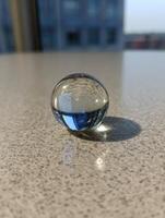 Asymmetric Blob Reflecting Light on a Smooth Surface in a Sunlit Room Near Urban Buildings photo