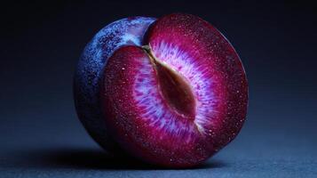 Ripe Plum Sliced in Two With a Glowing Core Showcasing a Mystical Aura Against a Dark Background photo