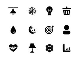 Set of 12 black solid icons featuring a ceiling lamp, snowflake, lightbulb, trash can, drop, heart rate, table lamp, flower, icons on white background vector