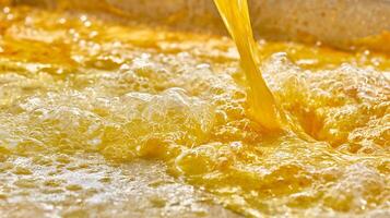 Vibrant Yellow Liquid Pouring Into Bubbling Pool Creating Dynamic Texture. photo