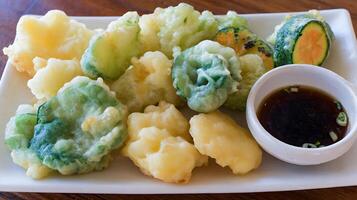 Delicious Japanese Vegetable Tempura Platter with Dipping Sauce. photo