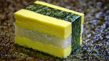 Delicious Layers of Sushi Egg, Rice, and Seaweed Treat. photo