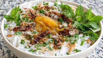 Savory Noodle Bowl with Pork and Fresh Mint Garnish. photo