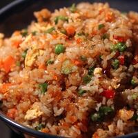 Delicious Fried Rice with Peas Carrots and Egg in a Bowl. photo