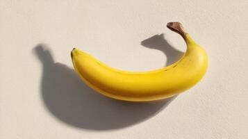 Conceptual Low Saturation Banana Casting a Shadow Against a Neutral Backdrop Creates an Artistic Visual in This Minimalistic Layout photo