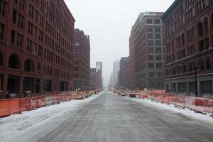 A street with snow on it and a construction site photo