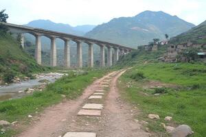 A bridge over a river with a train on it photo