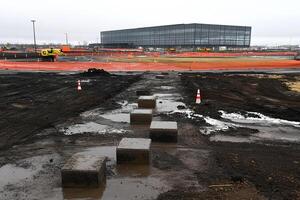 A construction site with a lot of dirt and construction equipment photo