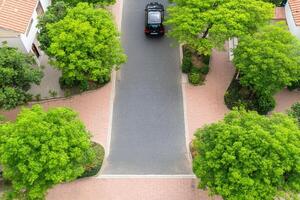 An aerial view of a car driving down a street photo