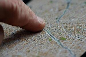 A person's finger is touching a map on a phone photo