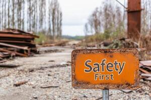 A rusty sign that says safety first photo