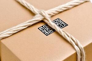 A brown box wrapped in rope with a qr code photo